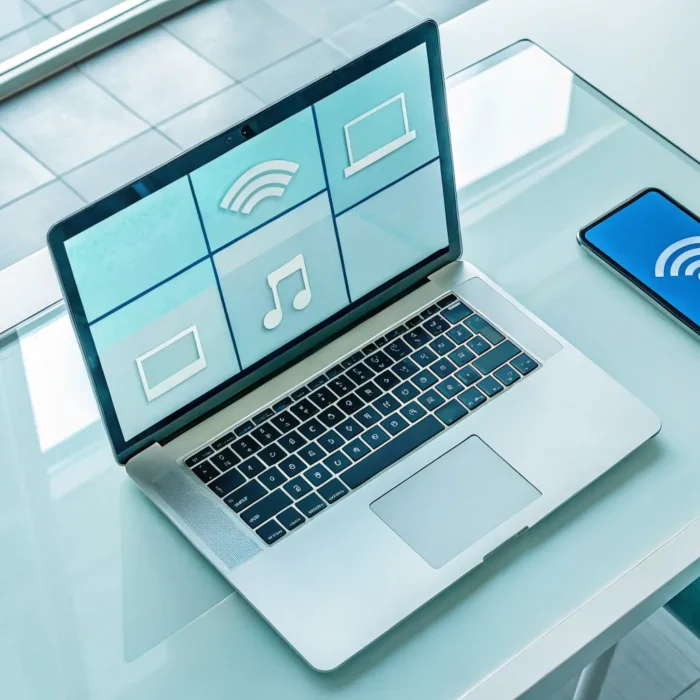 Laptop and smartphone displaying a radio player interface to find a stream URL.