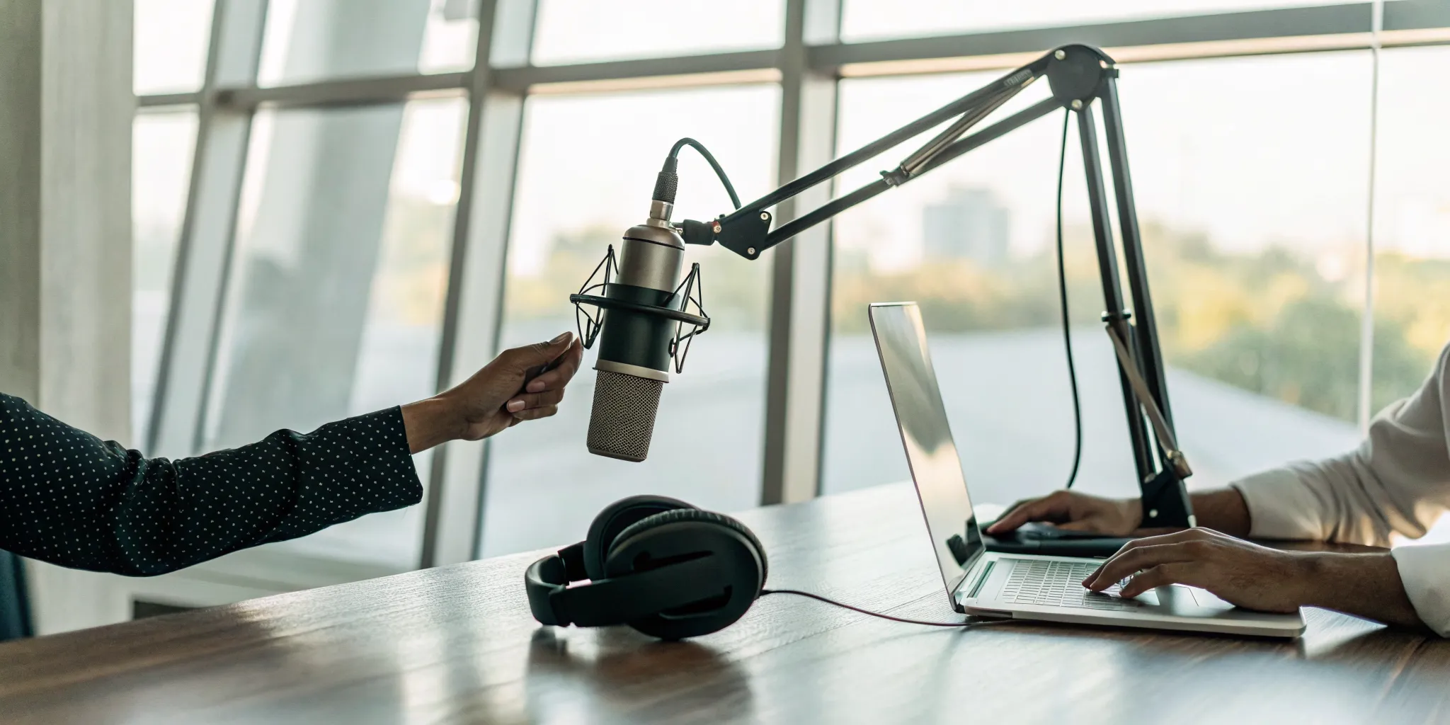 A microphone and headphones in a radio studio for getting your song on the radio.